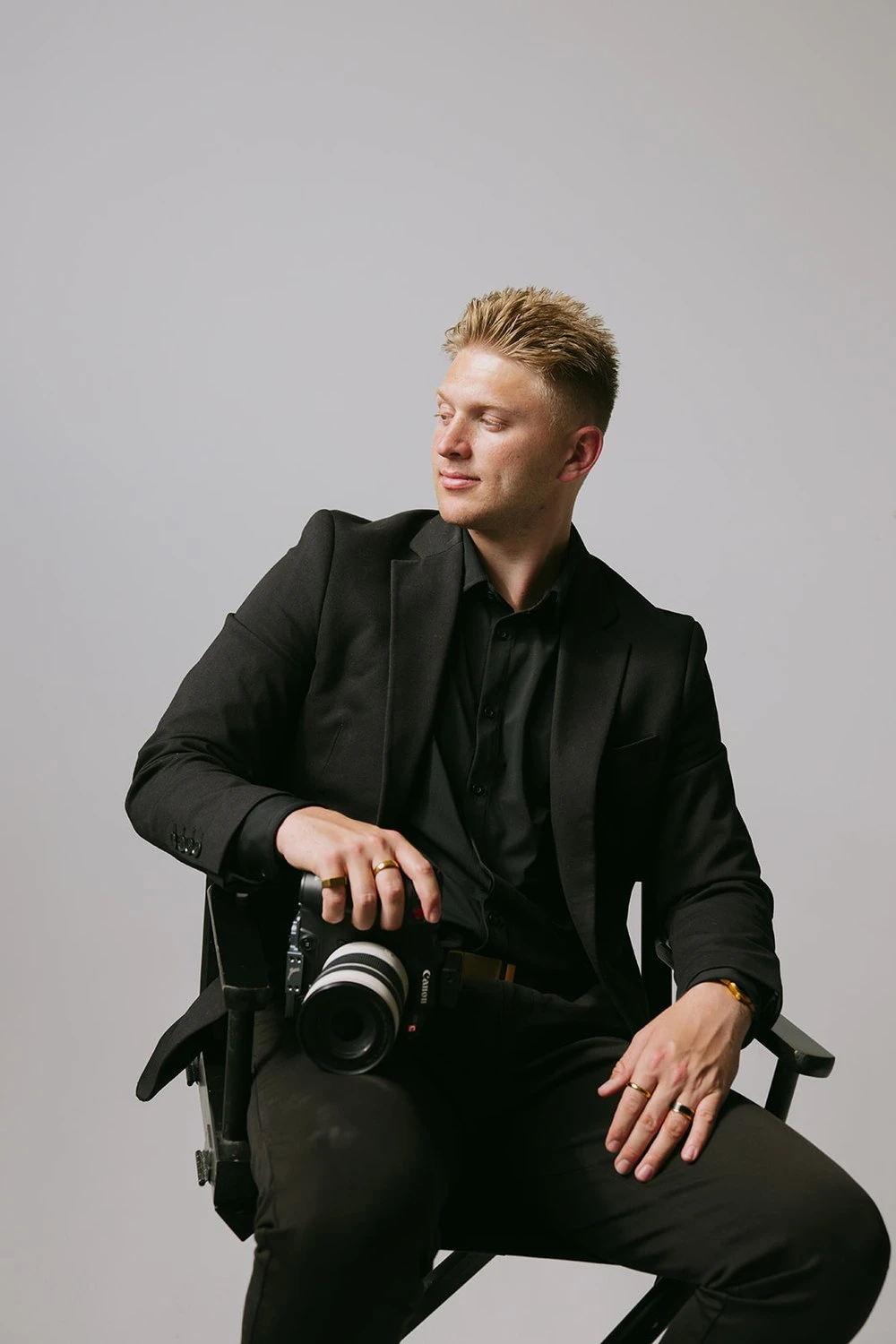 Dylan Simpson seated in a director's chair, cinema camera in hand