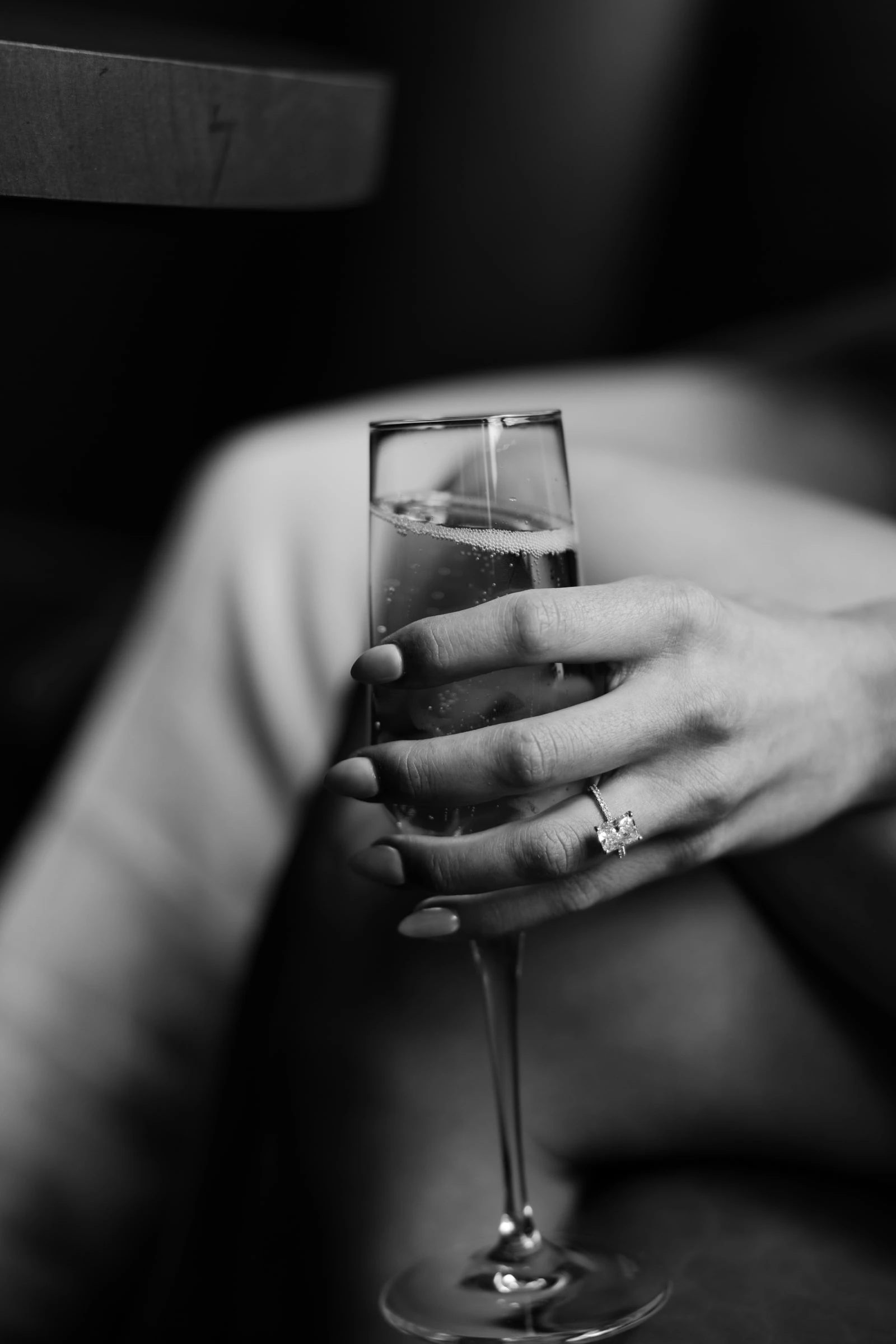 Bride holding a champagne glass, editorial detail