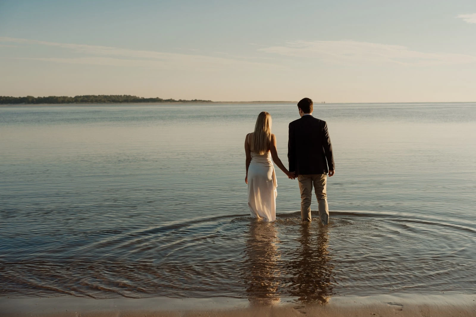 Couple on the shoreline at dusk