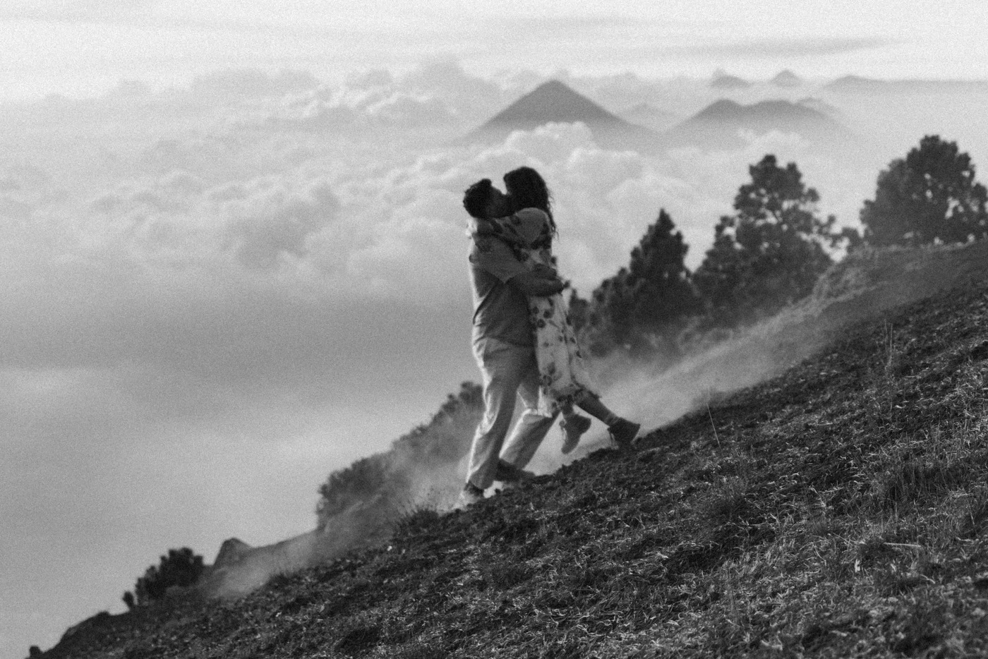 Couple embracing on a misty mountain ridge