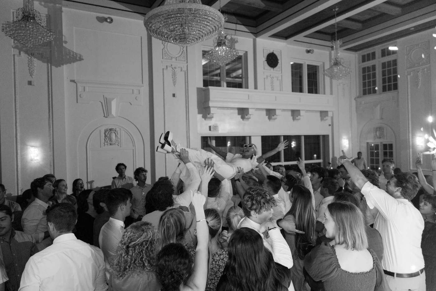 Grand ballroom mid-celebration, black and white