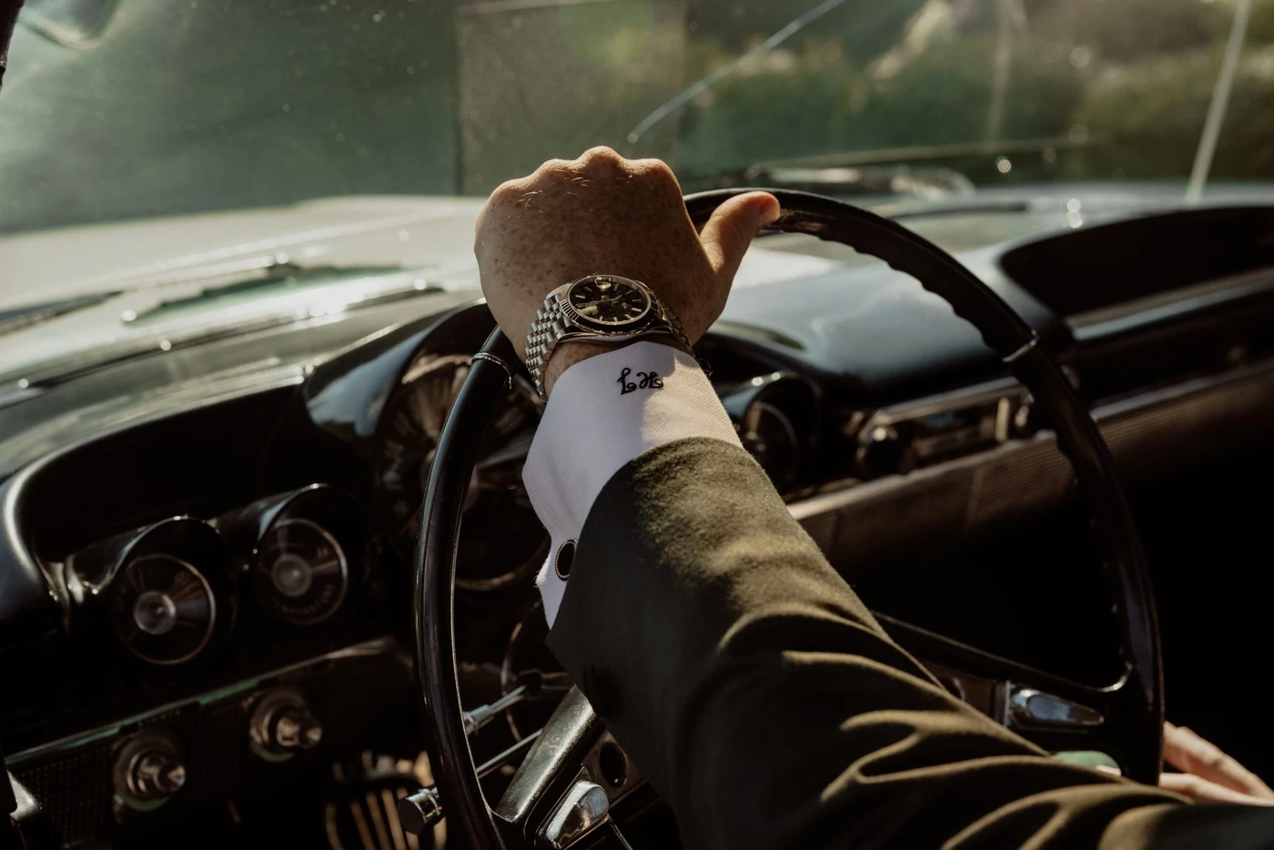 Hunter's watch on the steering wheel of the vintage getaway car