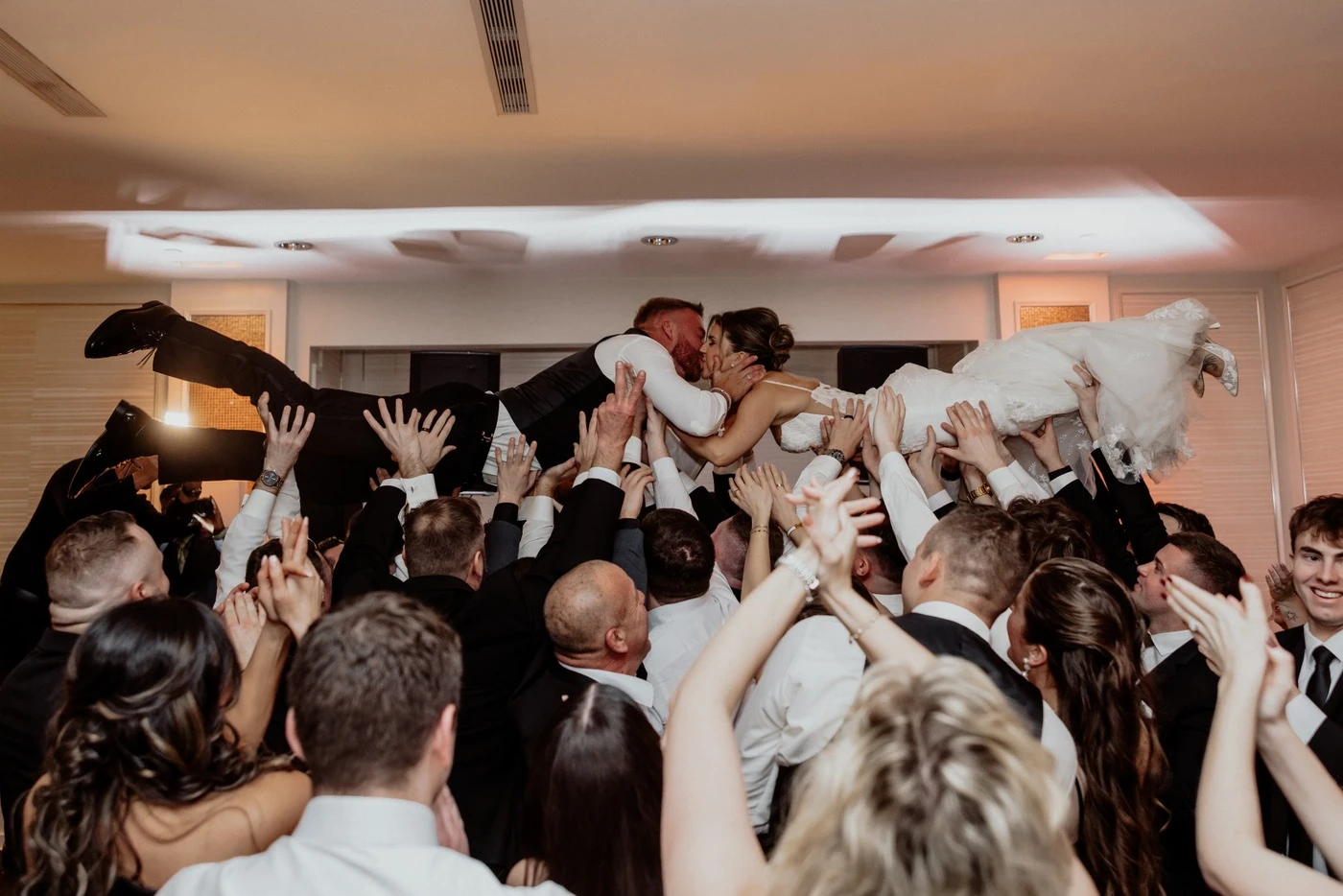 Tyler crowd-surfing over the wedding guests on the dance floor