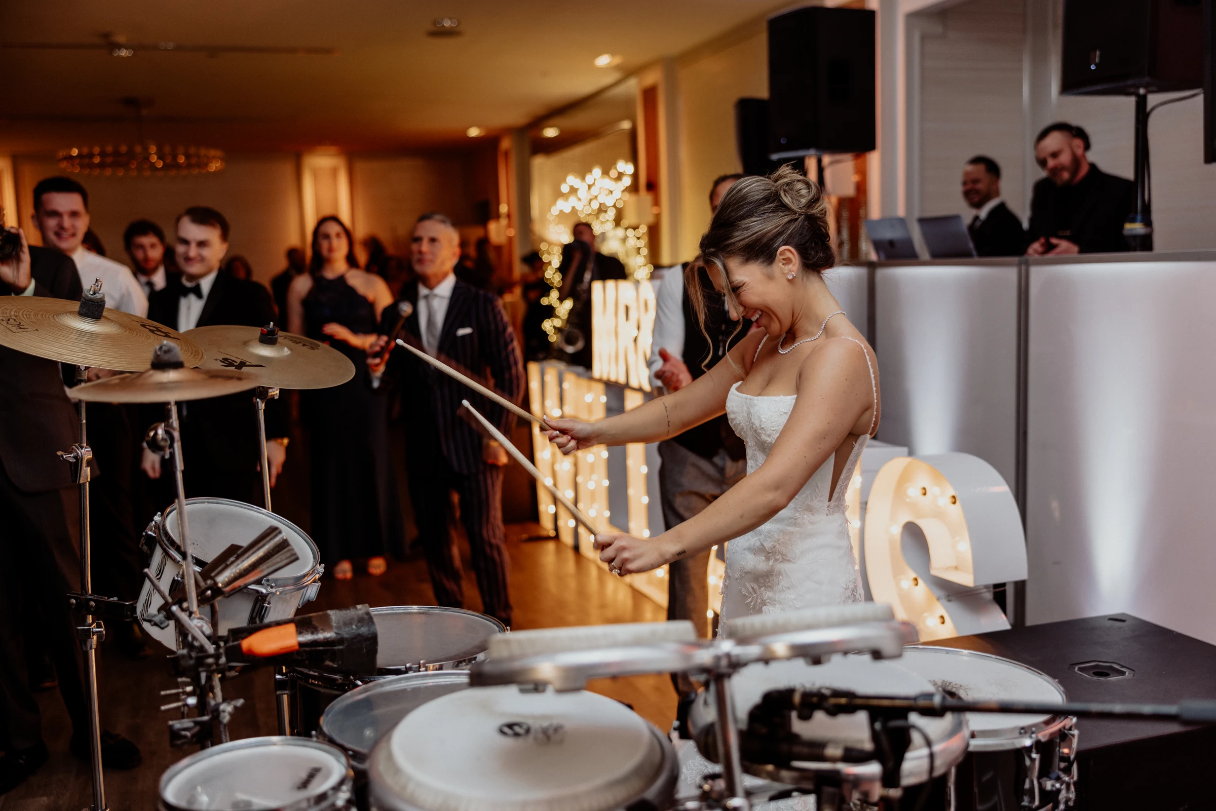 Meghan on the drums mid-song at The Piermont reception as the guests cheer her on