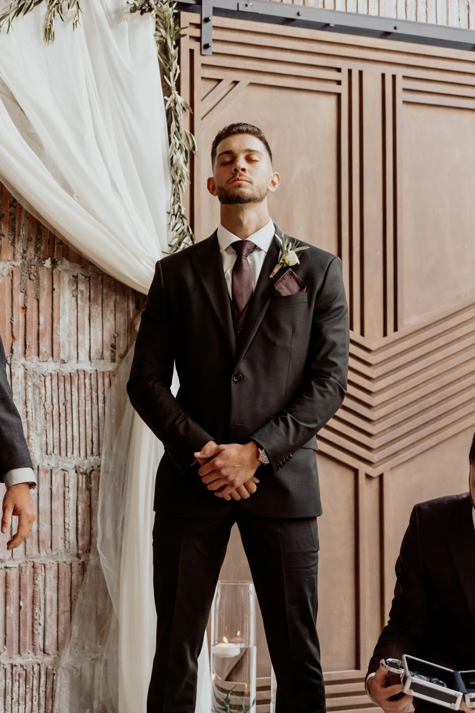 Groom waiting with his eyes closed before the first look