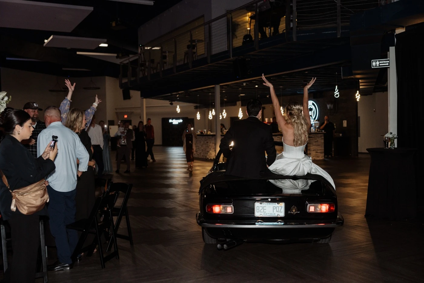 Bride riding through the reception with her arms in the air